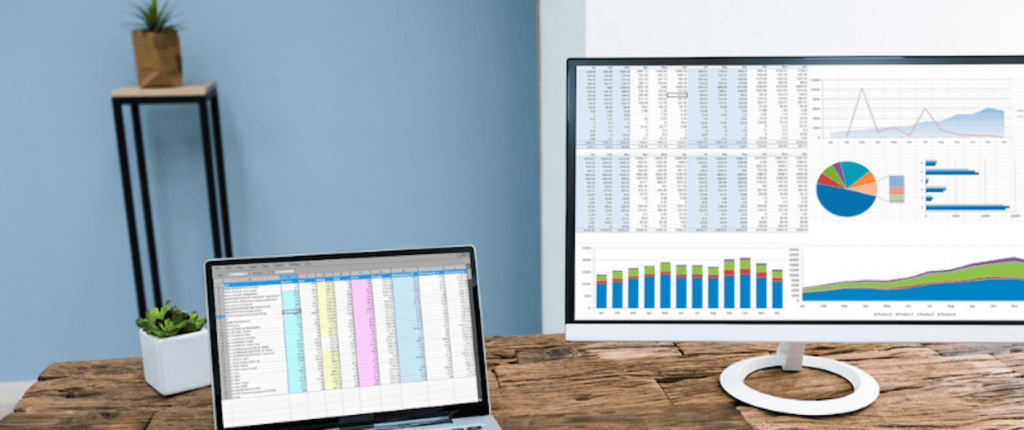 Two monitors with analytics in bright colors