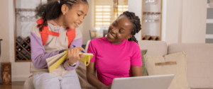 A mother and daughter at home conferring over back-to-school supplies