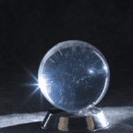 a crystal ball in a dark room, but glowing in spots to illustrate Signifyd's fraud prediction blog post