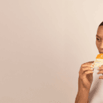 A woman consuming Cymbiotika vitamin supplement